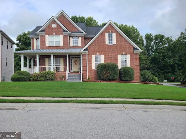 craftsman-style house featuring a porch and a front yard