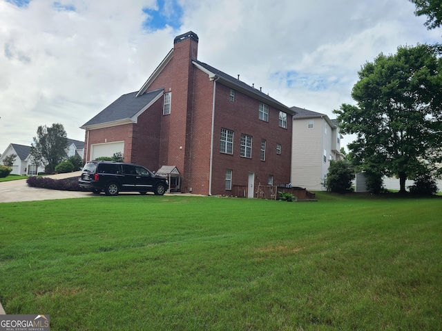 view of side of home with a garage and a lawn