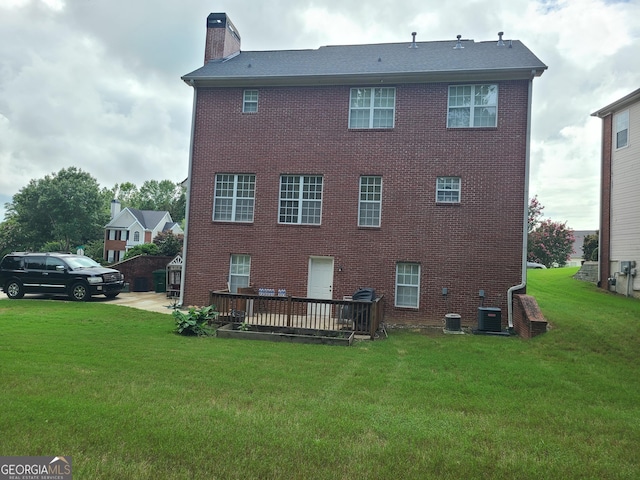 back of house with a wooden deck, a yard, and central air condition unit