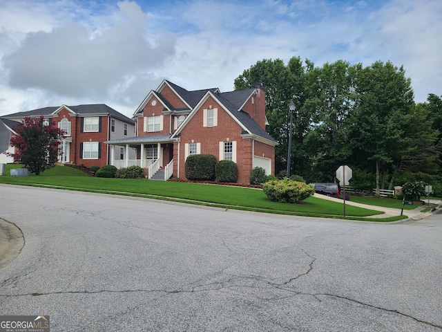 view of front of home with a garage and a front lawn