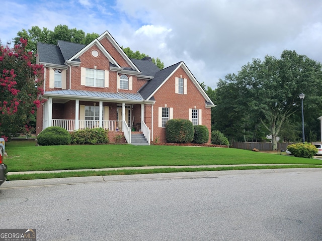 craftsman-style house featuring a porch and a front yard