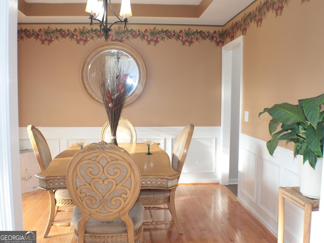 dining space with a notable chandelier and light wood-type flooring