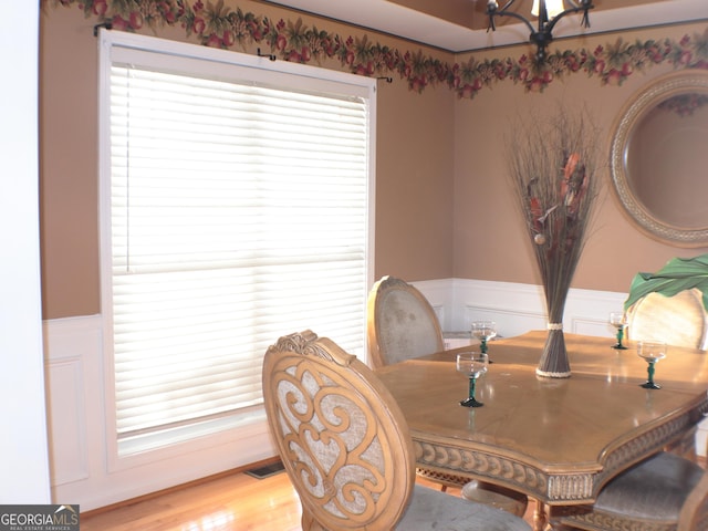 dining room with a chandelier and light wood-type flooring