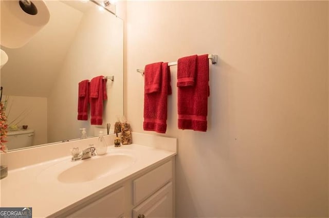 bathroom featuring vanity and toilet