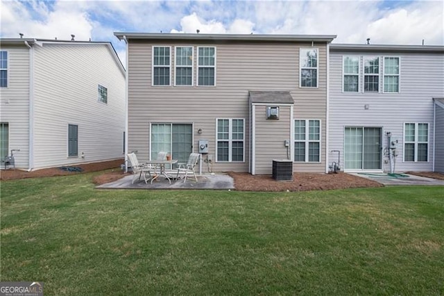 back of property with a patio and a lawn