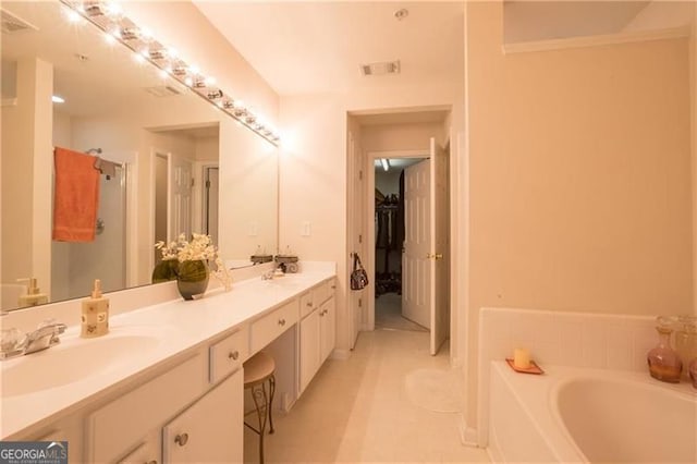 bathroom featuring independent shower and bath, vanity, and tile patterned floors