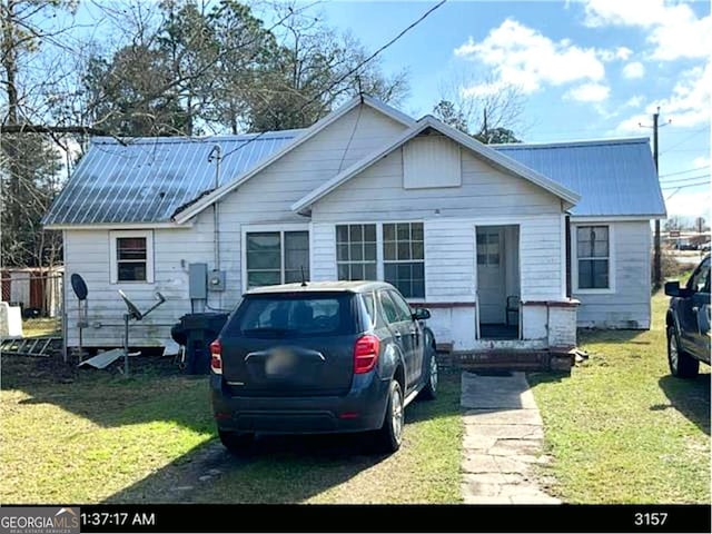 back of house with a lawn