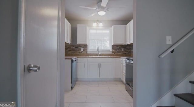 kitchen with tasteful backsplash, white cabinetry, appliances with stainless steel finishes, and sink