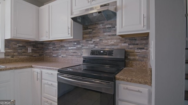 kitchen with white cabinetry, tasteful backsplash, and stainless steel electric range