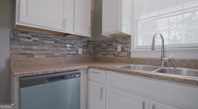 kitchen featuring white cabinetry, sink, backsplash, and stainless steel dishwasher