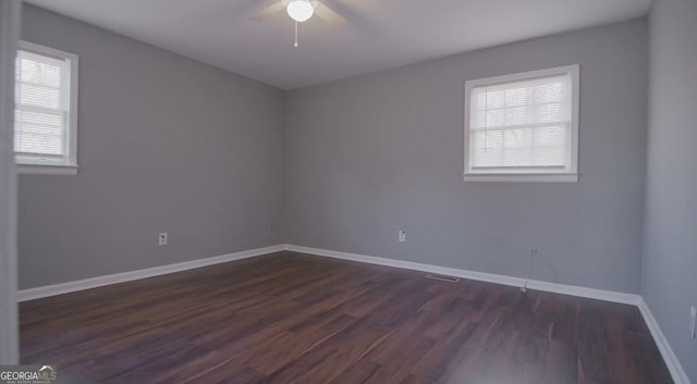 unfurnished room featuring ceiling fan and dark hardwood / wood-style flooring