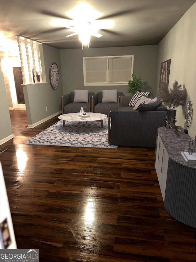 living room featuring dark hardwood / wood-style flooring and ceiling fan