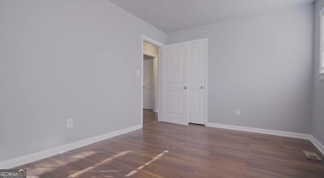 spare room with dark hardwood / wood-style flooring