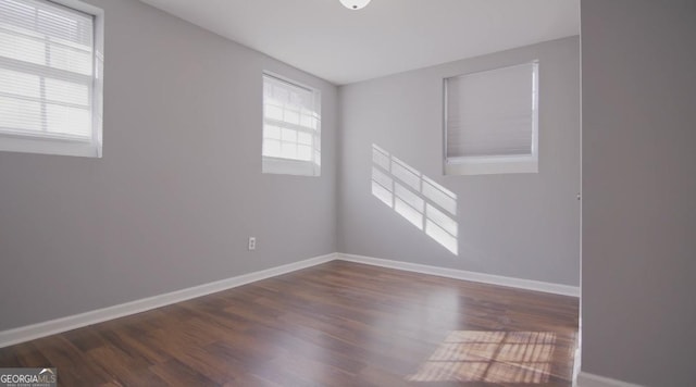 empty room with dark wood-type flooring