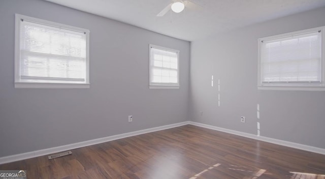 unfurnished room with ceiling fan and dark hardwood / wood-style flooring