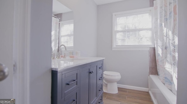 full bathroom featuring vanity, toilet, a healthy amount of sunlight, and shower / bath combo with shower curtain