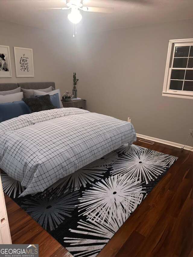 bedroom with dark wood-type flooring and ceiling fan