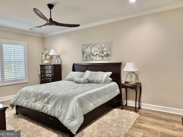 bedroom featuring ceiling fan, ornamental molding, and light hardwood / wood-style floors