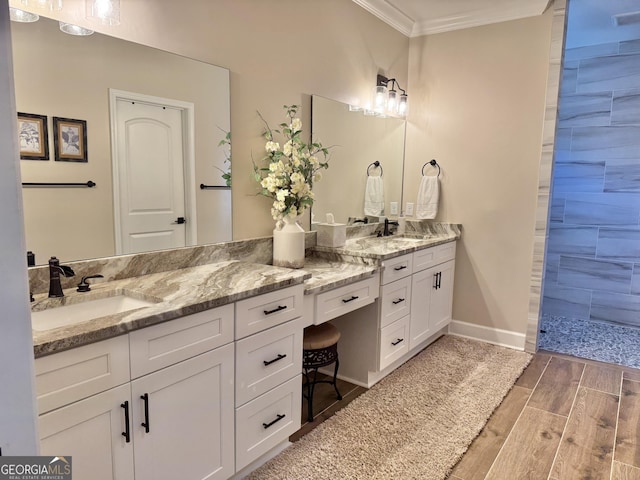 bathroom featuring vanity, crown molding, and a shower