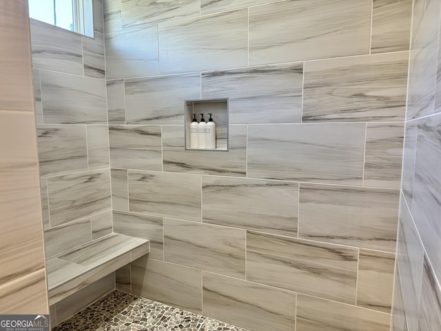 bathroom with a tile shower