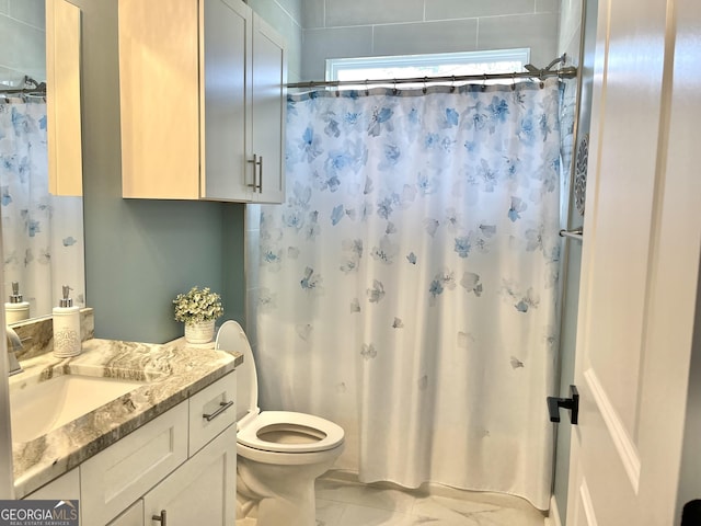 bathroom with vanity, toilet, and curtained shower