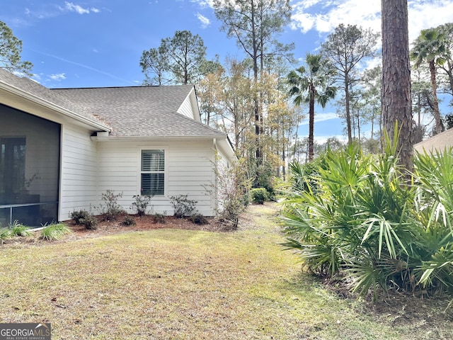 view of home's exterior with a yard