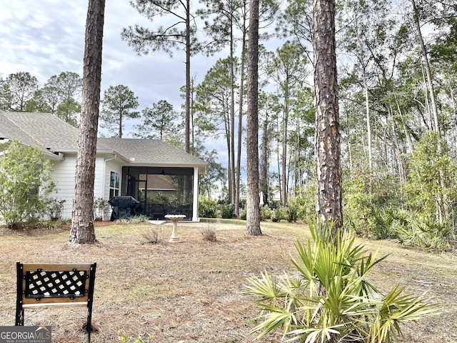 view of yard featuring a sunroom