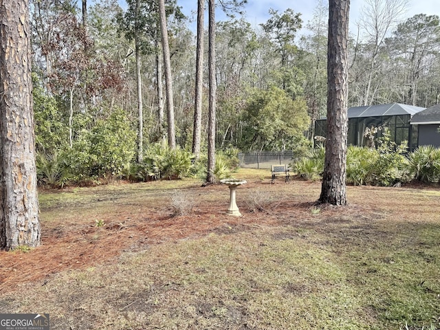 view of yard with glass enclosure