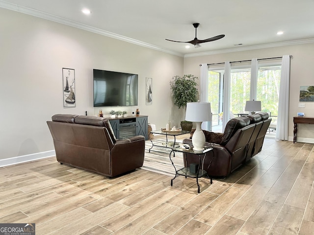 living room with crown molding, light hardwood / wood-style flooring, and ceiling fan