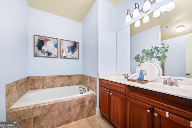 bathroom featuring a relaxing tiled tub and vanity