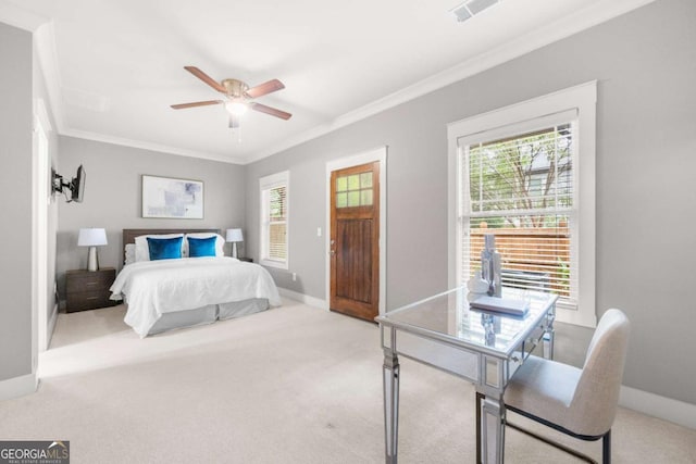 bedroom with crown molding, light colored carpet, and ceiling fan