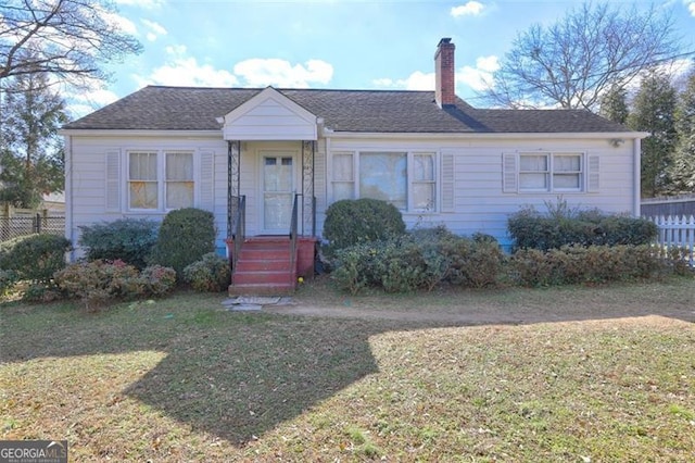 ranch-style home with a front lawn