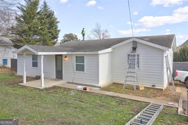 view of front of house featuring a front yard and a patio