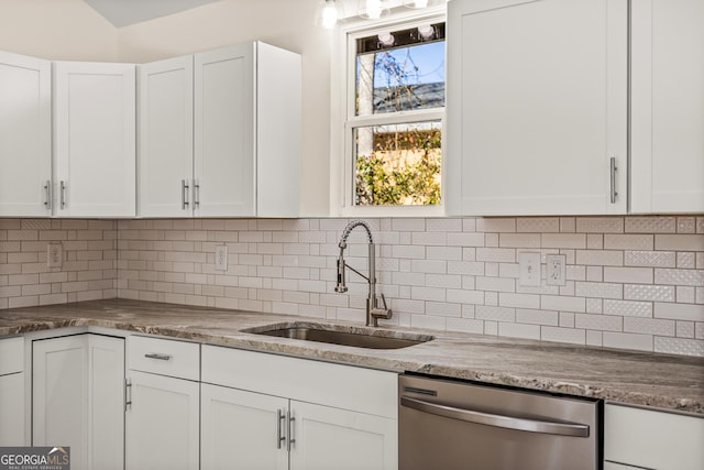 kitchen with white cabinetry, dishwasher, sink, and backsplash