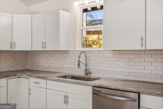 588 S Broad St, Toccoa, GA 30577 - kitchen featuring stainless steel dishwasher, white cabinetry, backsplash, and light stone counters