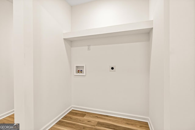 laundry room with electric dryer hookup, hookup for a washing machine, and hardwood / wood-style flooring