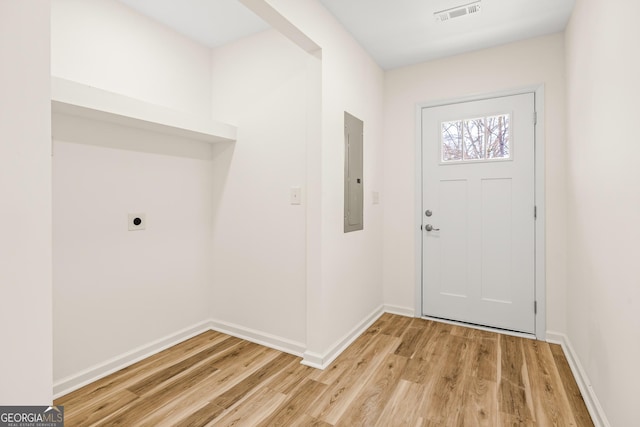 foyer entrance featuring light hardwood / wood-style floors and electric panel