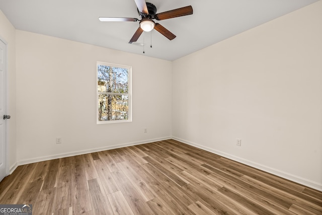 588 S Broad St, Toccoa, GA 30577 - empty room with wood finished floors and ceiling fan