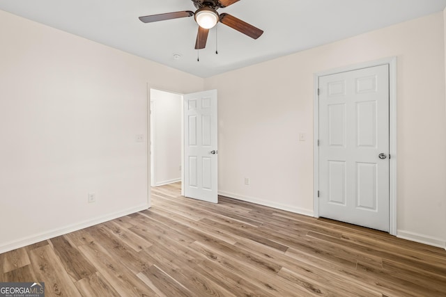 unfurnished bedroom featuring ceiling fan and light wood-type flooring