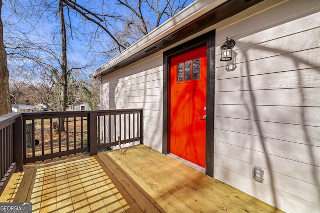 property entrance featuring a wooden deck