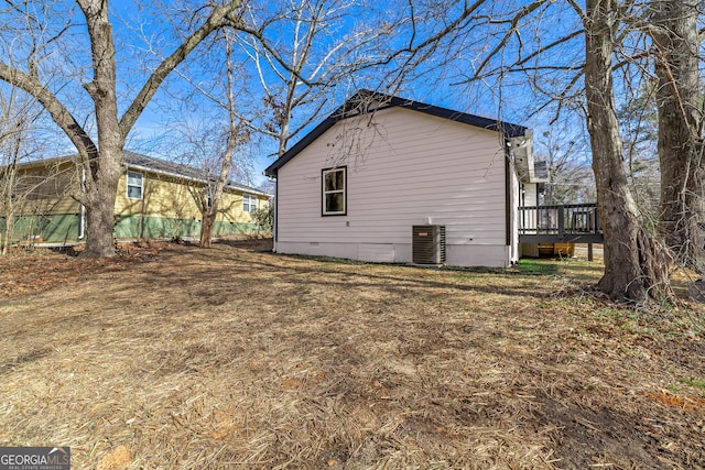 view of home's exterior featuring a yard, a deck, and central air condition unit