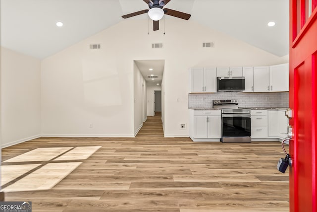 kitchen featuring ceiling fan, white cabinetry, backsplash, stainless steel appliances, and high vaulted ceiling