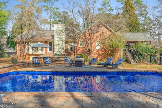 view of swimming pool with a fenced in pool and a patio area