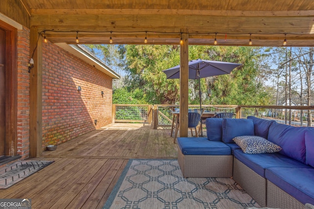 wooden terrace with an outdoor living space