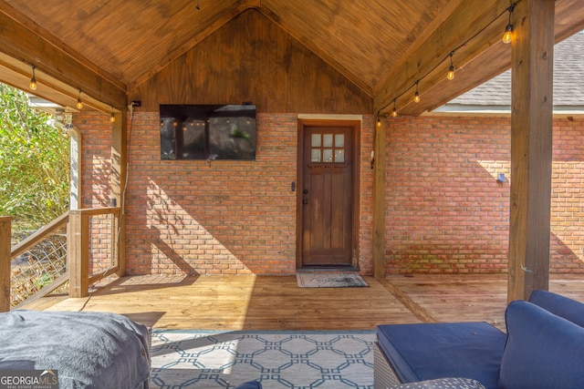 view of exterior entry with brick siding