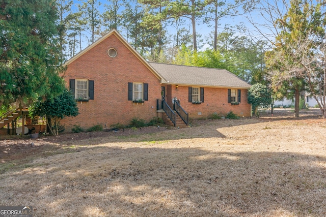 ranch-style house featuring crawl space, brick siding, stairway, and roof with shingles