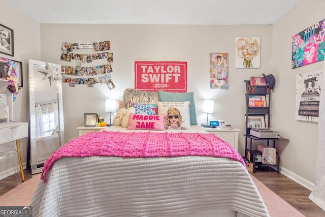 bedroom with baseboards and wood finished floors