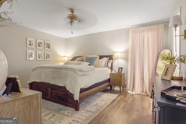 bedroom featuring a ceiling fan and wood finished floors