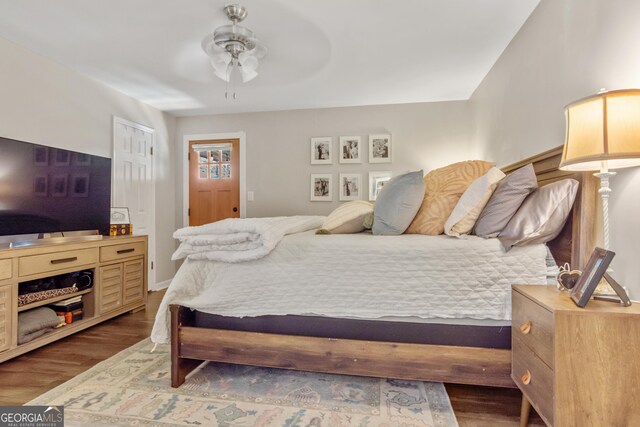 bedroom featuring ceiling fan and dark hardwood / wood-style floors