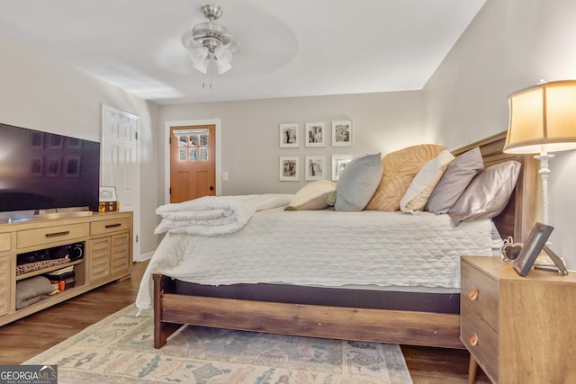 bedroom with dark wood finished floors and a ceiling fan